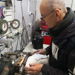 Figure skating coach David Reynolds sharpening a pair of figure skates.