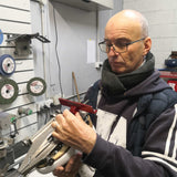 Coach David Reynolds checking for level edges on a pair of figure skates.