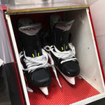 A pair of Bauer ice hockey skates in a specialised oven designed for heat moulding the boot.