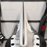 A view down the length of a flat, unsharpened ice hockey blade, with no groove and no edges.